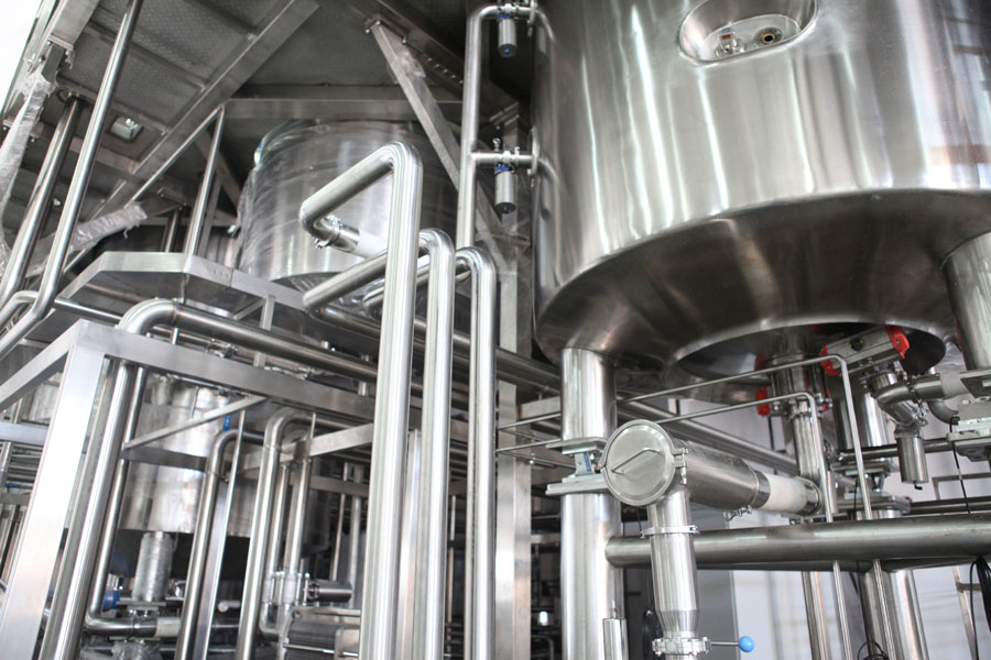 Stainless steel process tanks and piping in a food and beverage plant